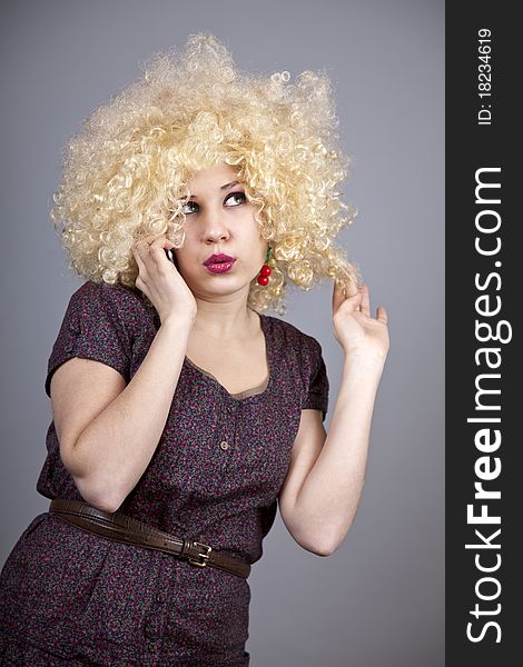 Funny girl in wig. Studio shot.