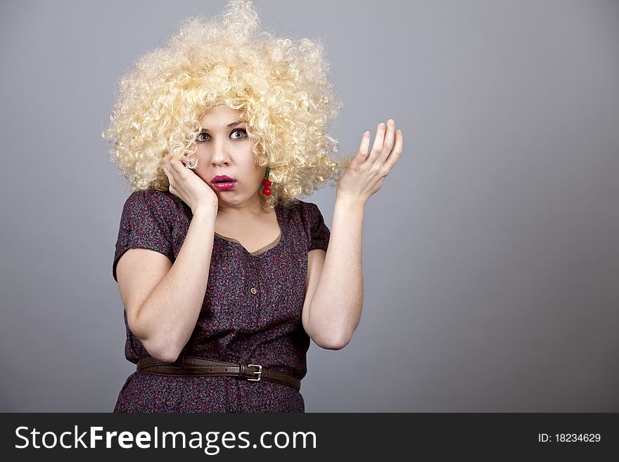 Funny girl in wig. Studio shot.