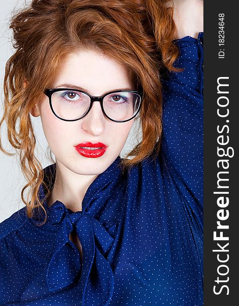 Portrait of beauty young woman with red hairs, in fashion eyeglasses