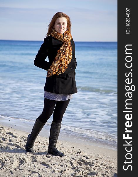 Red-haired girl at the beach. Outdoor shot.