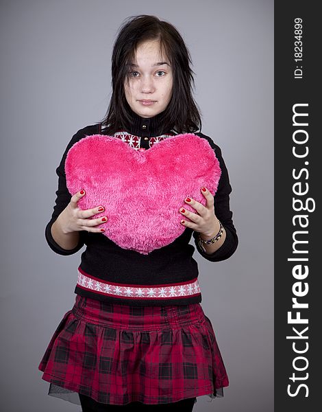 Funny gril with toy heart. Studio shot. Funny gril with toy heart. Studio shot.