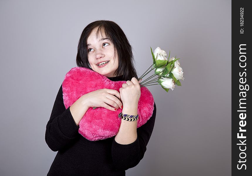 Funny gril with toy heart. Studio shot. Funny gril with toy heart. Studio shot.