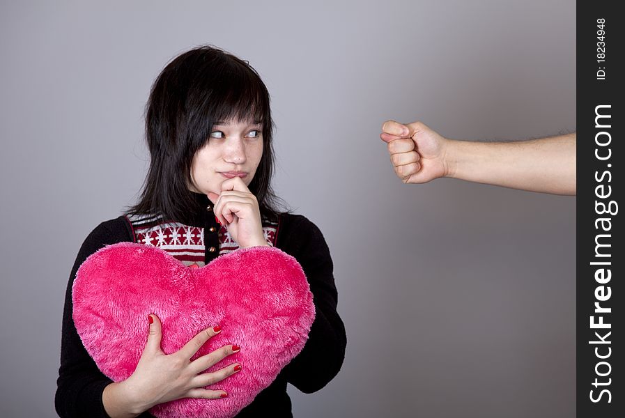 Funny girl with heart and fig. Studio shot.