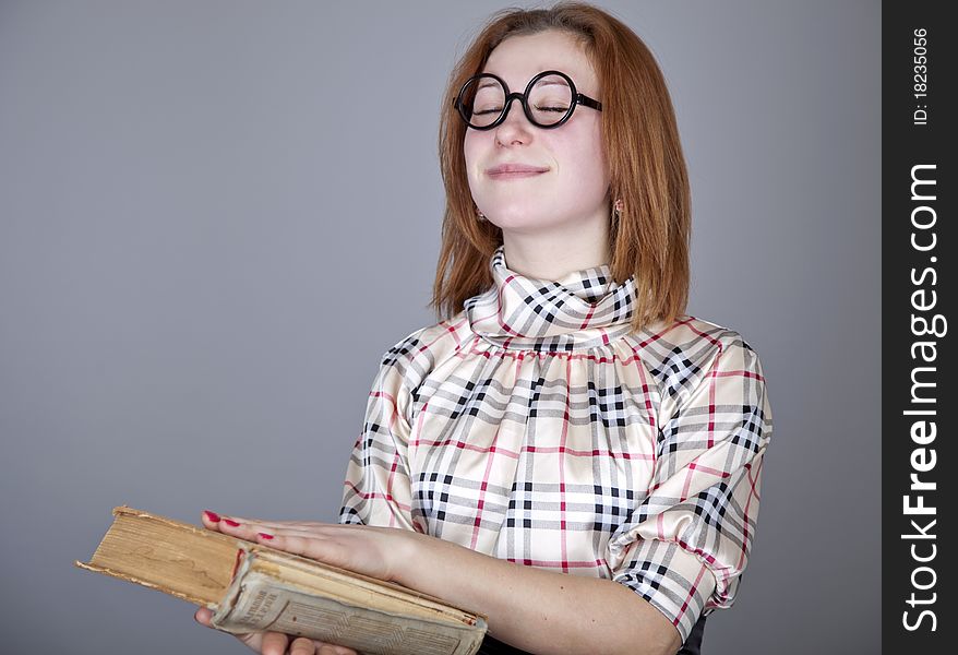 Funny girl with books. Studio shot.