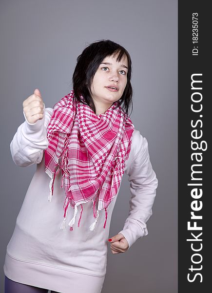 Funny girl in red scarf. Studio shot.