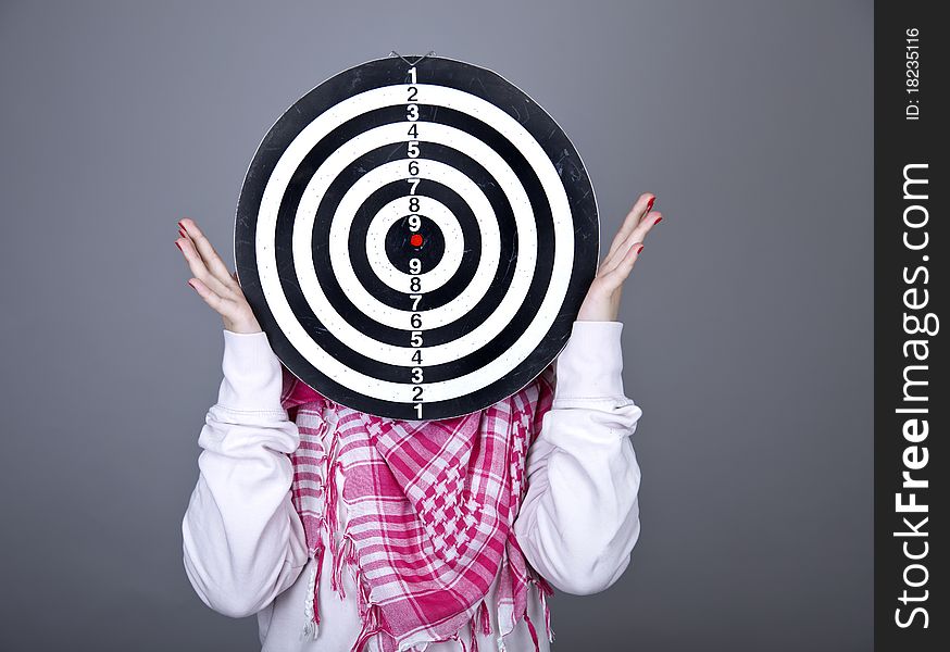 Girl with darts. Studio shot.