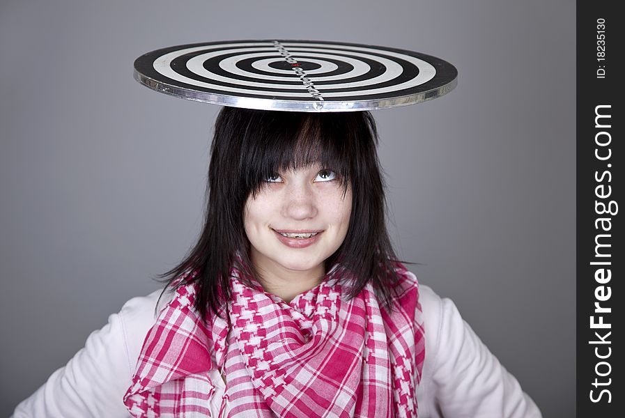 Girl with darts. Studio shot.