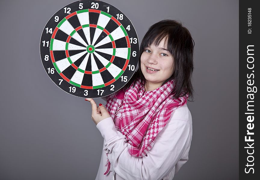 Girl with darts. Studio shot.