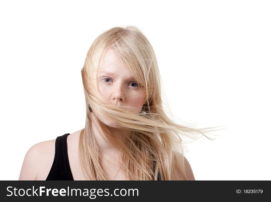 Blond hair is developing the wind on a white background