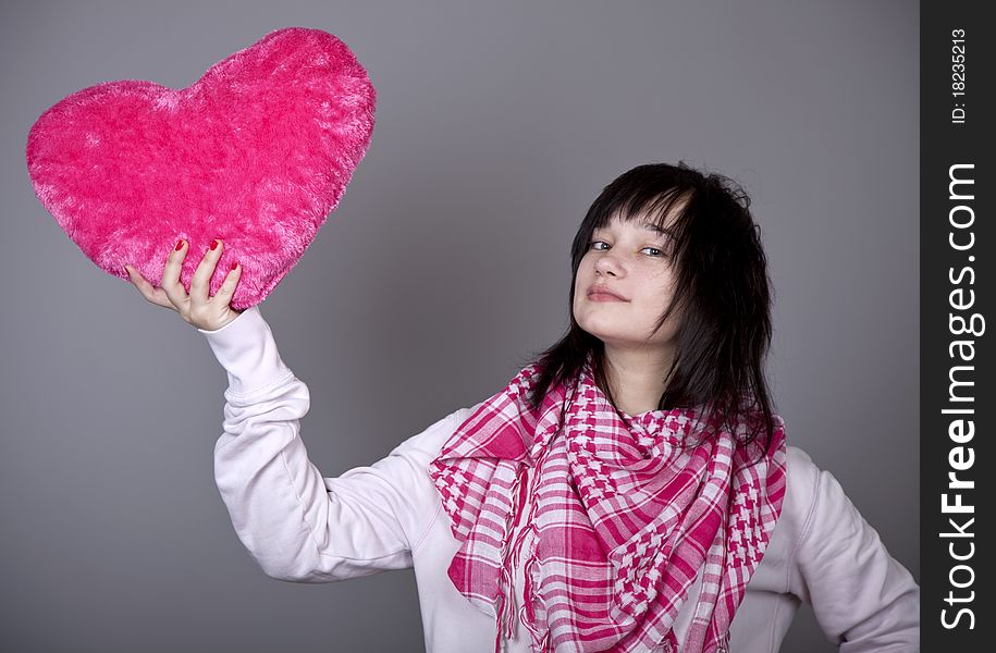 Funny gril with toy heart. Studio shot. Funny gril with toy heart. Studio shot.