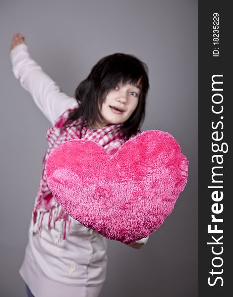 Funny gril with toy heart. Studio shot. Funny gril with toy heart. Studio shot.