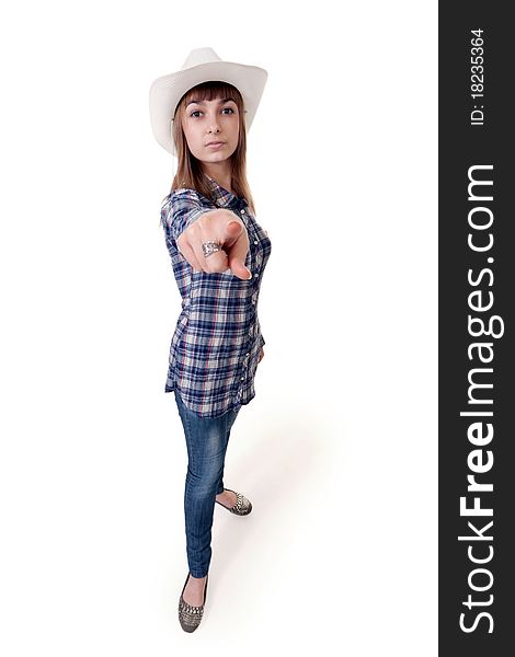 Girl in a hat shows his finger on a white background