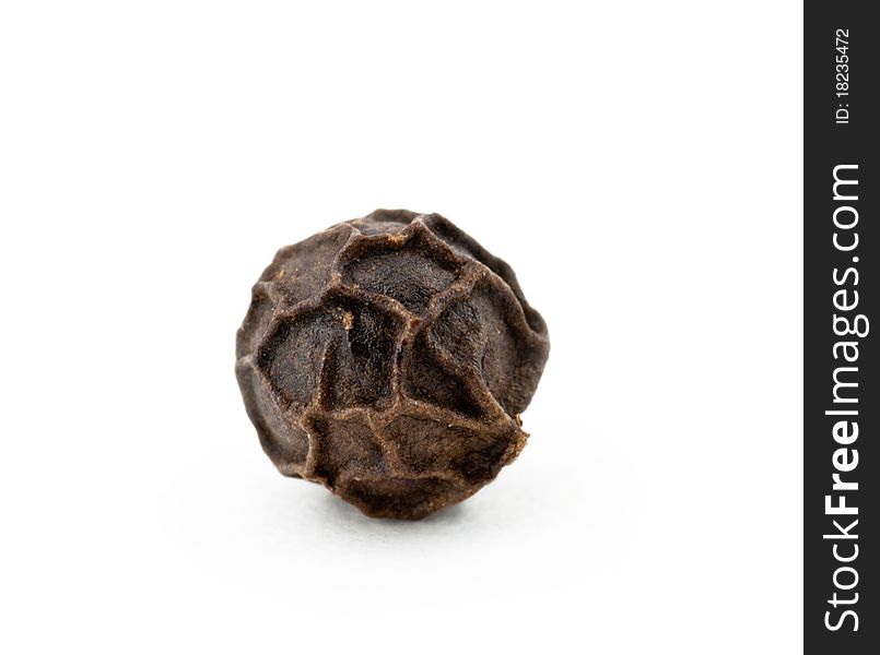 Black peppercorn against a white background