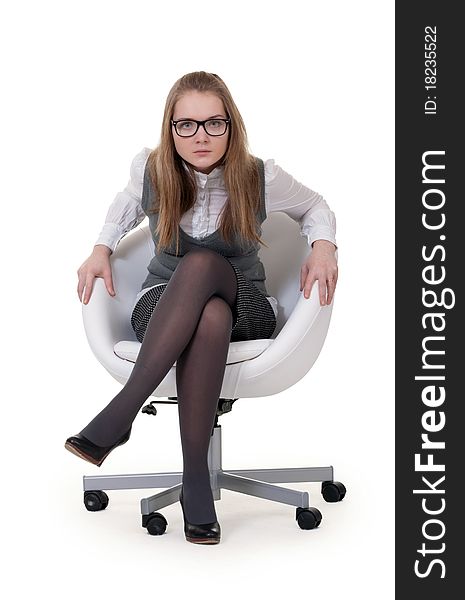 Strong girl sitting in an armchair on a white background