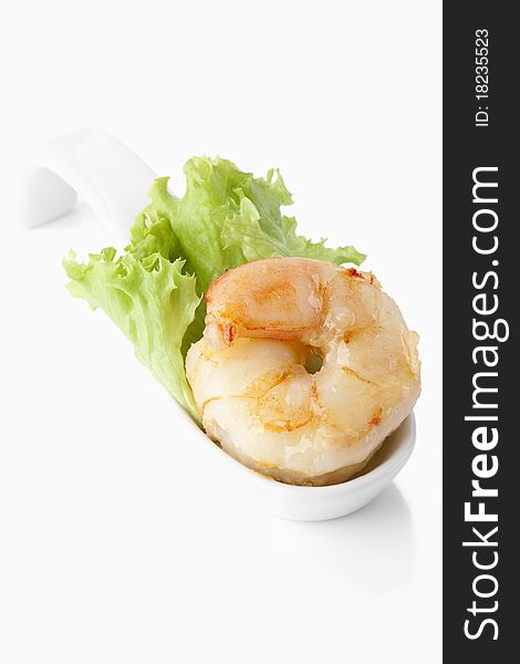 King prawn in a porcelain spoon on white background