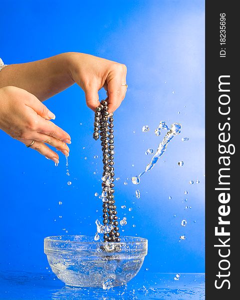 Washing beads in women's hand