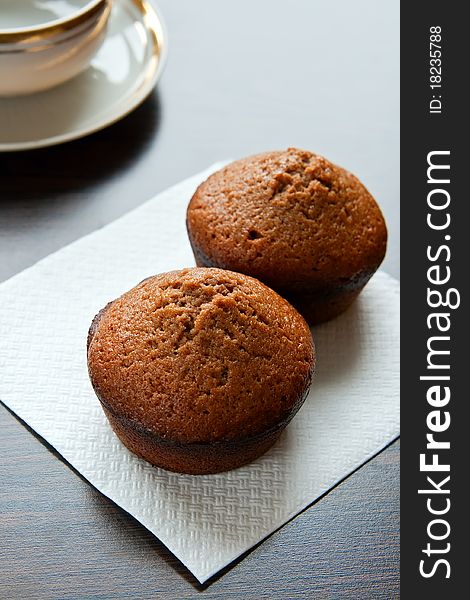 Close-up two chocolate muffins on a white placemat