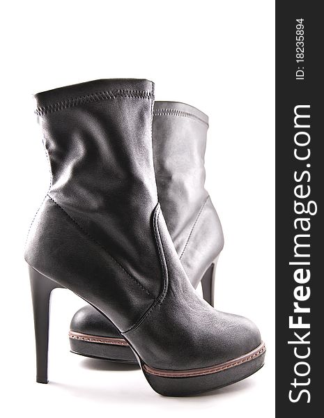 The Feminine leather boots on high heel on white background. The Feminine leather boots on high heel on white background.