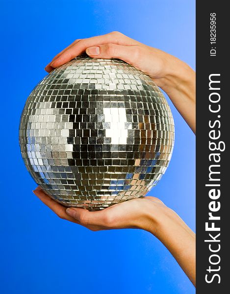 Mirror disco ball with reflections in hands. Mirror disco ball with reflections in hands