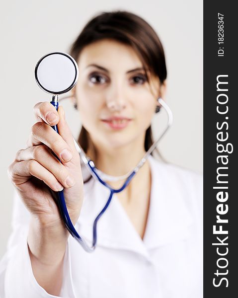 An image of young doctor holding stethoscope to camera. An image of young doctor holding stethoscope to camera