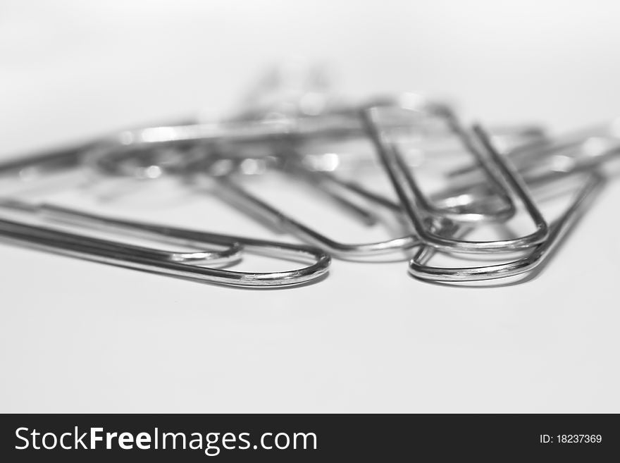 A closeup image of scattered paper clips