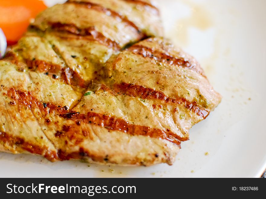 Grilled pork steak set with french fries and vegetable
