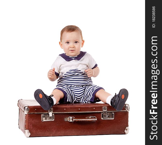 Little funny boy with suitcase isolated on white