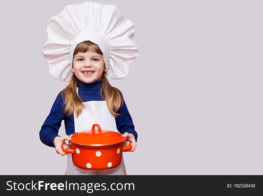 Cute girl in chef uniform hold saucepan isolated on white background