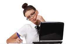 Woman With Glasses Sits At A Table And Working Royalty Free Stock Images
