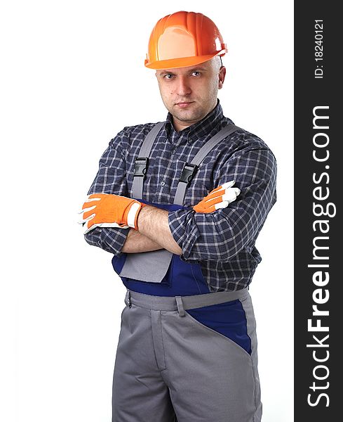 The man in the workers' clothes in 
a helmet on a white background. The man in the workers' clothes in 
a helmet on a white background