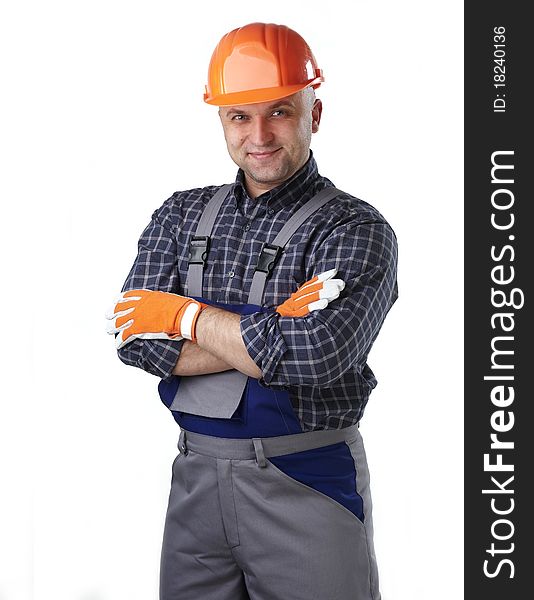 The man in the workers' clothes in a helmet on a white background. The man in the workers' clothes in a helmet on a white background