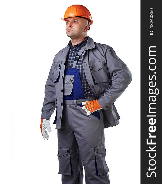 The man in the workers' clothes in 
a helmet on a white background. The man in the workers' clothes in 
a helmet on a white background