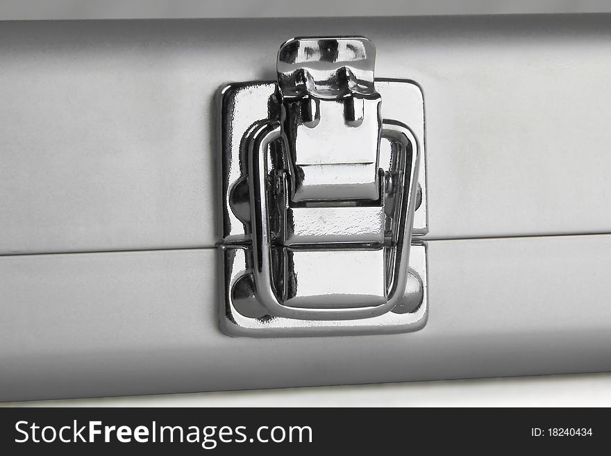 Chromated latch of small grey suitcase