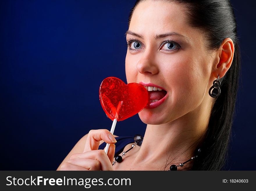 Beautiful young woman holding a red heart. Valentine concept