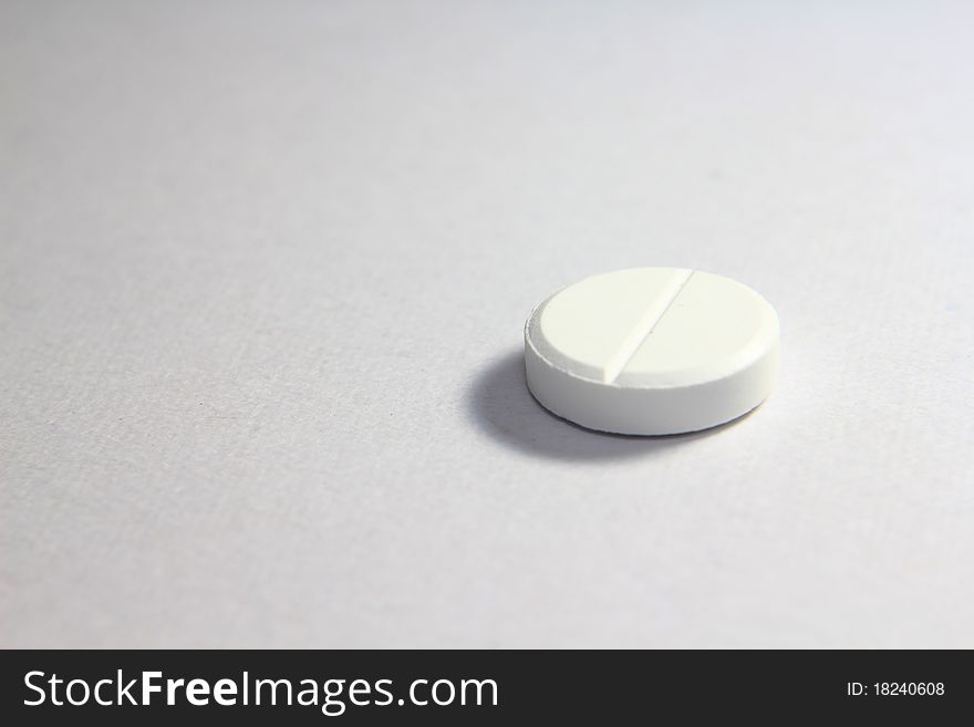 A macro shot of medicines, white tablets. A macro shot of medicines, white tablets