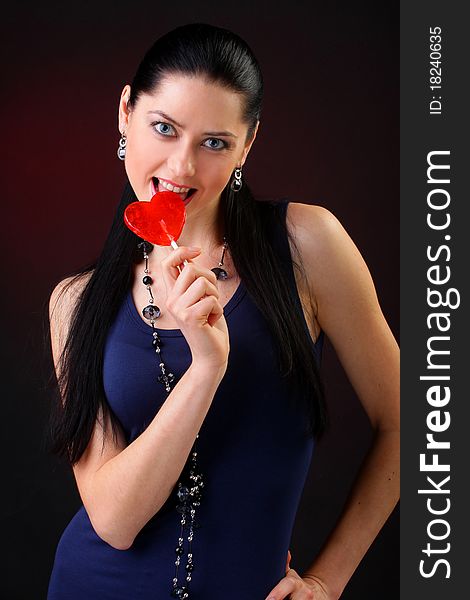 Beautiful young woman holding a red heart. Valentine concept