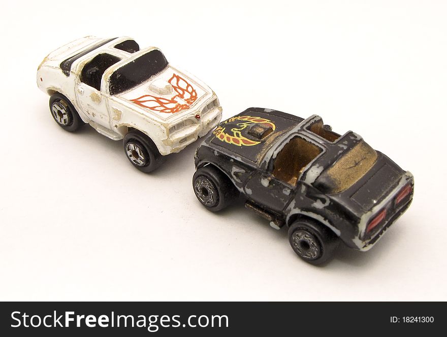 Face to face old toy cars with white background