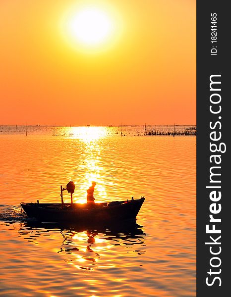 Fisherman on the boat at Sunset. Fisherman on the boat at Sunset