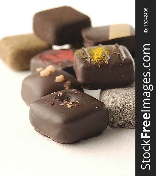 Delicious luxurious chocolate bonbons on light background. Delicious luxurious chocolate bonbons on light background