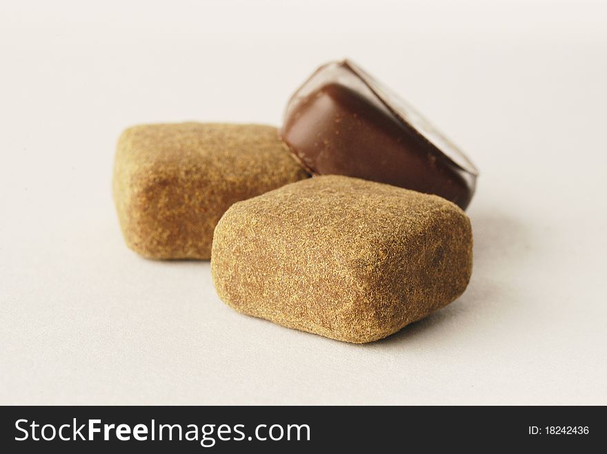 Delicious luxurious chocolate bonbons on light background. Delicious luxurious chocolate bonbons on light background
