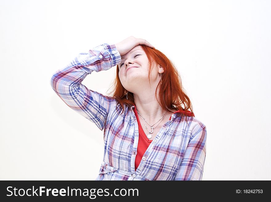 Redhead young woman holding her hand to the head