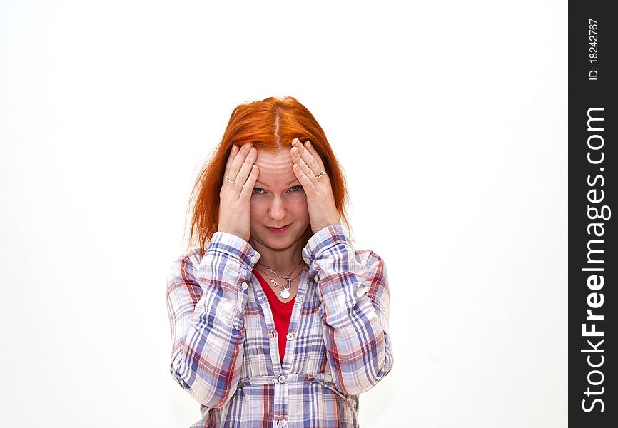 Redhead young woman holding her hand to the head with headache