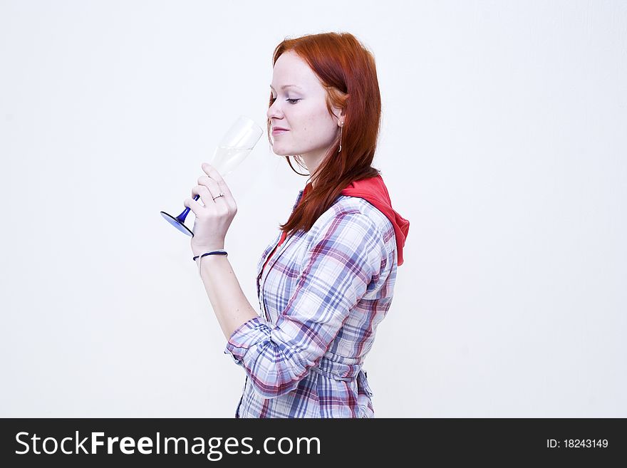 Redhead young woman is drinking from glass wine