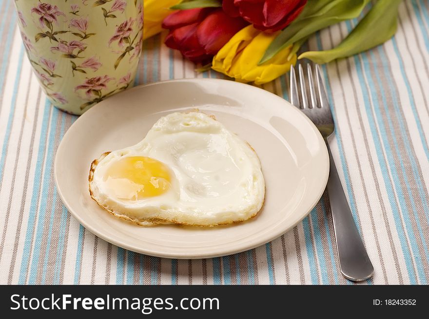 Tea, fried egg and tulips. Tea, fried egg and tulips