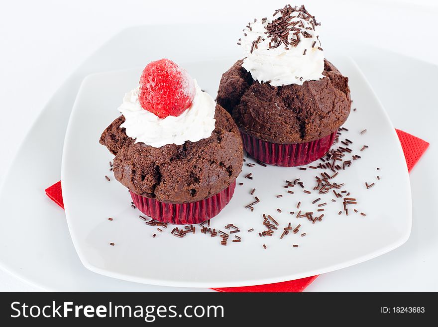 Chocolate muffins with decoration on the plate.