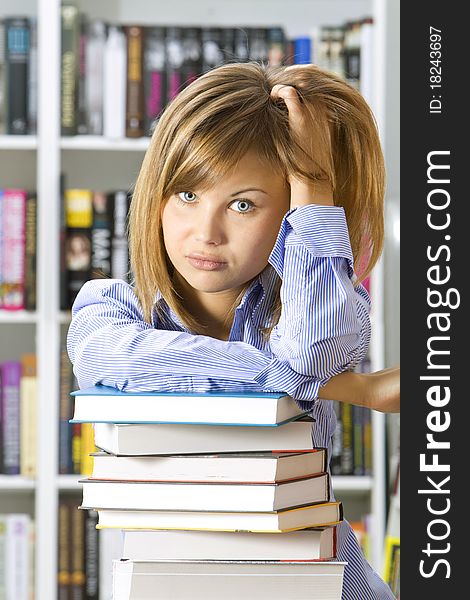 Young woman with books for reading in the library