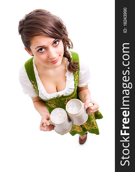 Bavarian girl holding two mugs of beer and smiling. Bavarian girl holding two mugs of beer and smiling