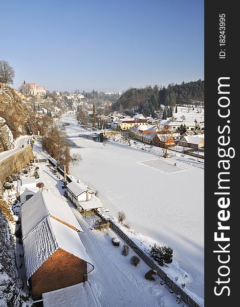 Small historical church and river Luznice in Bechyne