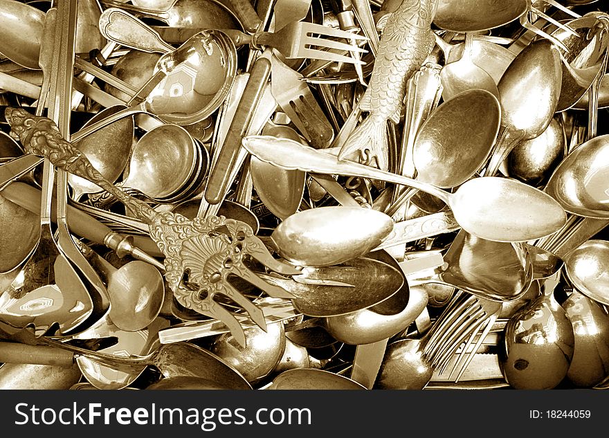 Golden antique spoons and forks as background