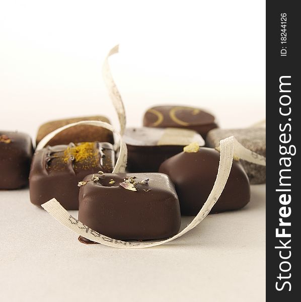 Delicious luxurious chocolate bonbons on light background. Delicious luxurious chocolate bonbons on light background